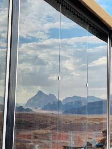 a window with a view of the desert and mountains at Rum Aranda camp & Jeep Tour in Wadi Rum