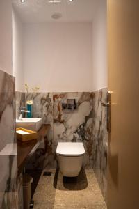 a bathroom with a toilet and a sink at The Saints Inn in Athens