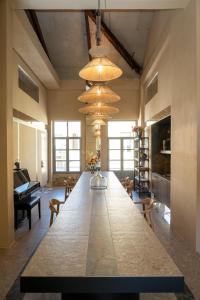a large long table in a room with a piano at The Saints Inn in Athens