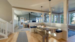 a large living room with a wooden table and windows at 3-Home Coastal Retreat w Sauna Firepit Greenhouse Seabright Haven by AvantStay in Coupeville