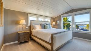 a bedroom with a large bed and a window at 3-Home Coastal Retreat w Sauna Firepit Greenhouse Seabright Haven by AvantStay in Coupeville