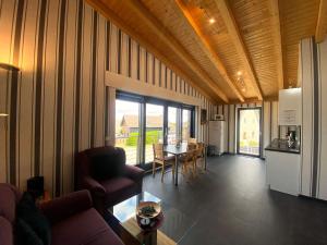 a living room with a couch and a table and a kitchen at Wohnung In Schmidt Mit Grill Und Garten in Nideggen