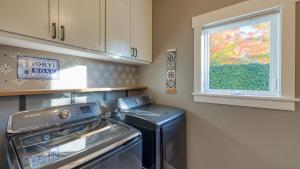 a kitchen with a dishwasher and a window in it at 3-Home Coastal Retreat w Sauna Firepit Greenhouse Seabright Haven by AvantStay in Coupeville +52 photos