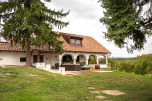 a white house with a red roof at Balaton Cottage - Your Hide Away in Cserszegtomaj