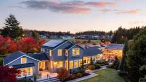 an aerial view of a house with a sunset at 3-Home Coastal Retreat w Sauna Firepit Greenhouse Seabright Haven by AvantStay in Coupeville