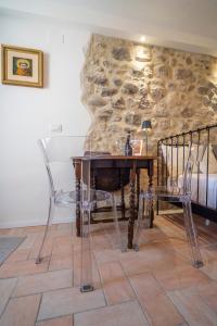 a bedroom with a table and chairs and a bed at Torretta dependance in Assisi