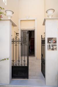 an entrance to a house with a black gate at The Saints Inn in Athens