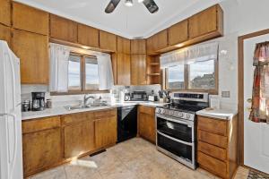 a kitchen with wooden cabinets and a stove top oven at Lead Haven Lodge in Lead
