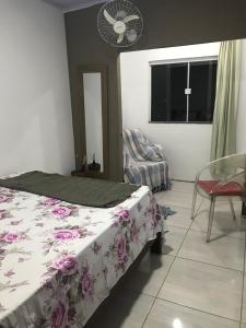 a bedroom with a bed and a window and a fan at casa Hamburgo in Búzios
