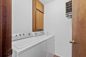 a kitchen with a white washer and dryer at Lead Haven Lodge in Lead +19 photos