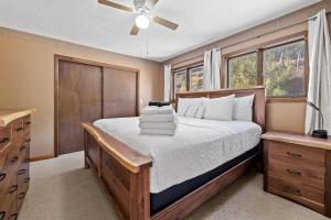 a bedroom with a bed and a ceiling fan at Lead Haven Lodge in Lead