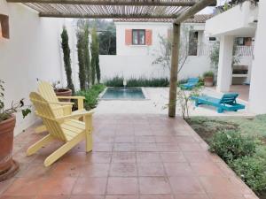 a patio with two chairs and a pool at Casapueblo Rent Cachagua CP 18 in Cachagua
