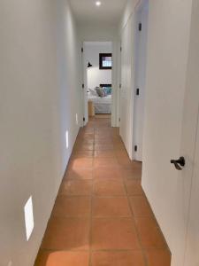 Casapueblo Rent Cachagua CP 18 في Cachagua: ممر مع أرضية بلاط وغرفة نوم
