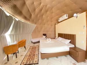 a bedroom with a bed in a tent at Rum Aranda camp & Jeep Tour in Wadi Rum