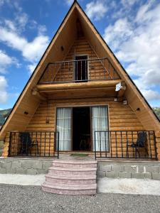 a log cabin with a thatched roof at Borjomi-sadgeri comfort in Borjomi