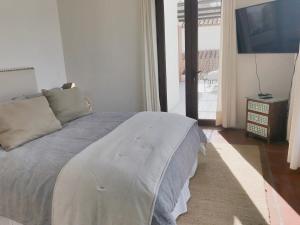 a bedroom with a large bed and a television at Casapueblo Rent Cachagua CP 05 in Cachagua
