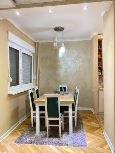 a dining room with a table and chairs at Rustic Elegance Suite in Vrbas