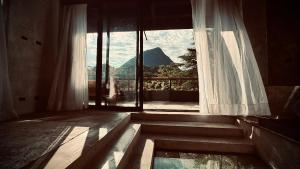 a room with a large window with a view at Cerro Tusa Springs in Venecia