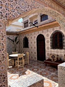 a patio with a table and chairs in a building at Villa Haryouli in Azemmour +21 photos