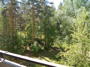 a view of a forest from a balcony at Laajavuori Apartment in Jyväskylä