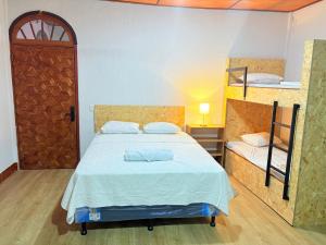 a bedroom with a bed and two bunk beds at Casa Azucena in Flores