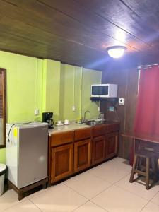 a kitchen with a sink and a tv in it at Hospedaje Angeluz in Quesada +18 photos