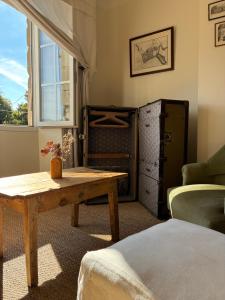 a room with a table and a bed and a window at ferme st pierre 2 suites avec repas, piscine, clim, cheminée ou baignoire spa in Chabeuil