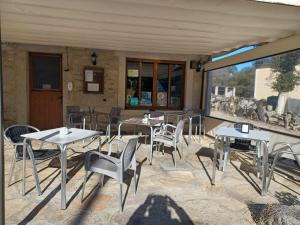 een terras met tafels en stoelen in een gebouw bij Albergues O Abrigo Miraz  +13 foto's