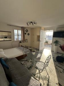 a bedroom with a bed and a table and chairs at Bellissimo apartment Naxos in Naxos Chora