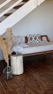 a bed in a room with a vase on the floor at ALMAR Cabaña Boutique Frente al Mar in La Pedrera