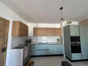 a kitchen with a sink and a refrigerator at Penthouse with Jacuzzi -Sannat in Sannat