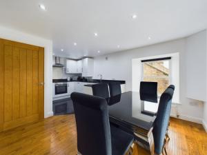 a kitchen and dining room with a table and chairs at Queen Elizabeth Penthouse Sleeps 6-8 in Stanhope