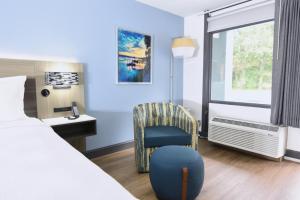 a hotel room with a bed and a chair and a window at Best Western Point South in Yemassee +52 photos