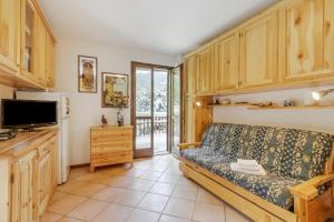 a living room with a couch and a tv at Relax In Pineta - Happy Rentals in Oulx