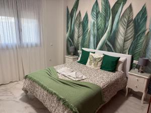 a bedroom with a bed with a large mural on the wall at AljaLux Sevilla Bormujos in Bormujos