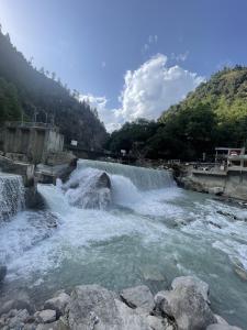 aluence of two waterfalls in a river at Neelam Water View Hotel in Kundālshai +3 photos