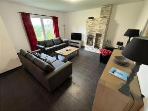 a living room with a couch and a fireplace at Villa Slupečná in Lipno nad Vltavou