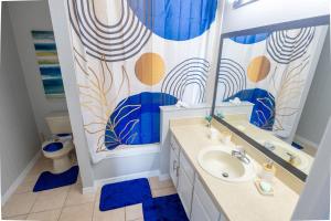 a bathroom with a sink and a shower curtain at Casa Kissimmee in Orlando +12 photos