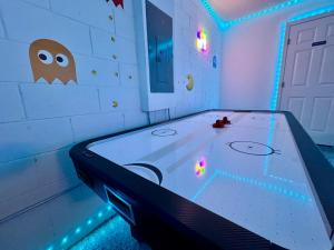 a room with a pool table with lights on it at Casa Kissimmee in Orlando