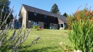 a house with a garden in front of it at Séjour Bien-Être et Saveurs Bio, au calme avec vue sur la vallée, près du Mont Saint Michel in Braffais