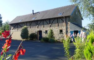 a large stone building with a gambrel roof at Séjour Bien-Être et Saveurs Bio, au calme avec vue sur la vallée, près du Mont Saint Michel in Braffais +7 photos