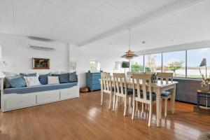 a living room with a couch and a table and chairs at 30194-Malling-Fjordvej-26 in Norsminde