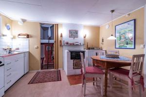 a kitchen with a table and chairs and a kitchen with a stove at VGO860-Tranemo-Ryda-Ryfors-kvarn-1 in Östra Ryda