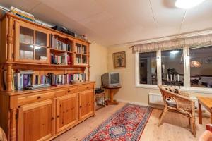 a living room with a large wooden book shelf at VGO860-Tranemo-Ryda-Ryfors-kvarn-1 in Östra Ryda