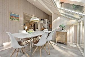 a dining room with a white table and chairs at N334-Karrebaeksminde-Reedtzholmvej-127 in Enø By