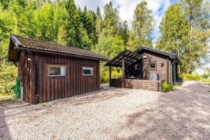 a couple of buildings on a gravel road at VAR799-Torsby-Bada-125-a in Klätten