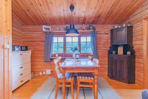 a kitchen with a table and chairs in a cabin at VAR799-Torsby-Bada-125-a in Klätten