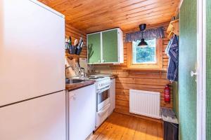 a kitchen with white appliances and a wooden ceiling at VAR799-Torsby-Bada-125-a in Klätten
