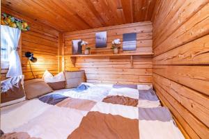 a bedroom with a bed in a wooden cabin at VAR799-Torsby-Bada-125-a in Klätten
