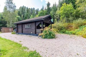 a small cabin in the middle of a yard at VAR799-Torsby-Bada-125-a in Klätten +7 photos